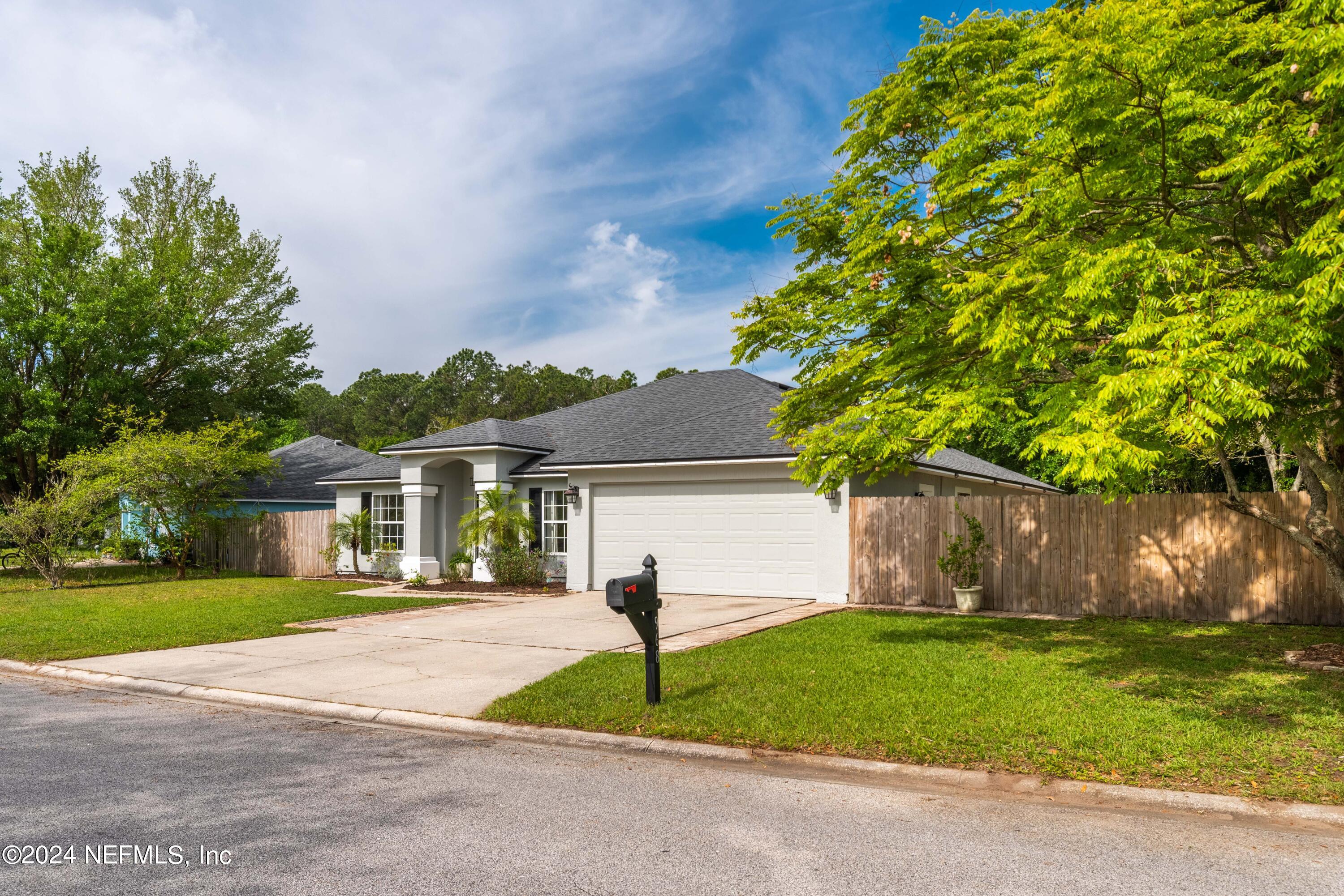 968 Deer Spring Drive Jacksonville, FL 32221 - Photo 31 of 31 a front view of a house with a garden and plants