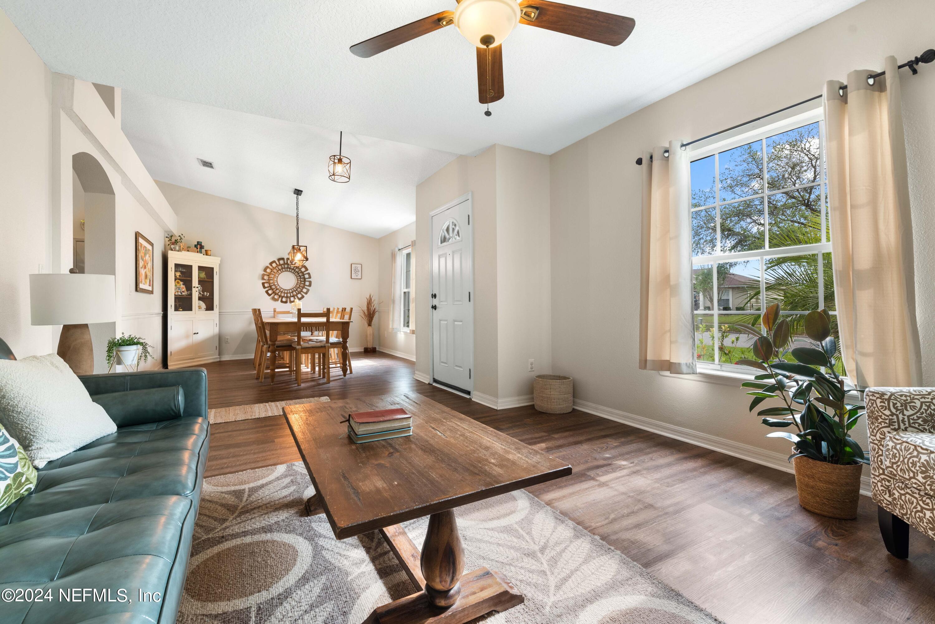 968 Deer Spring Drive Jacksonville, FL 32221 - Photo 6 of 31 a living room with furniture windows and a chandelier