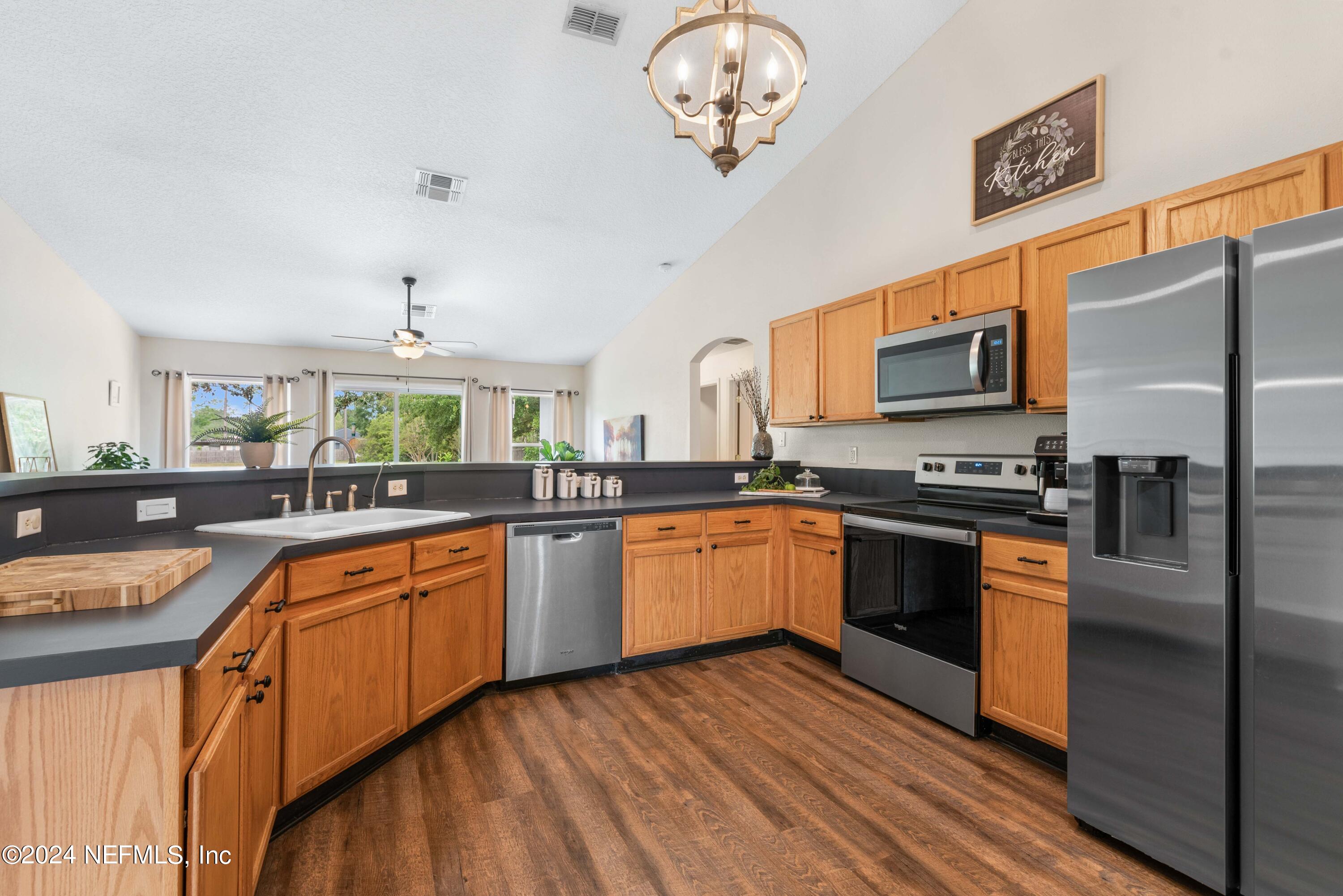 968 Deer Spring Drive Jacksonville, FL 32221 - Photo 9 of 31 a kitchen with stainless steel appliances granite countertop a refrigerator a stove a sink and dishwasher