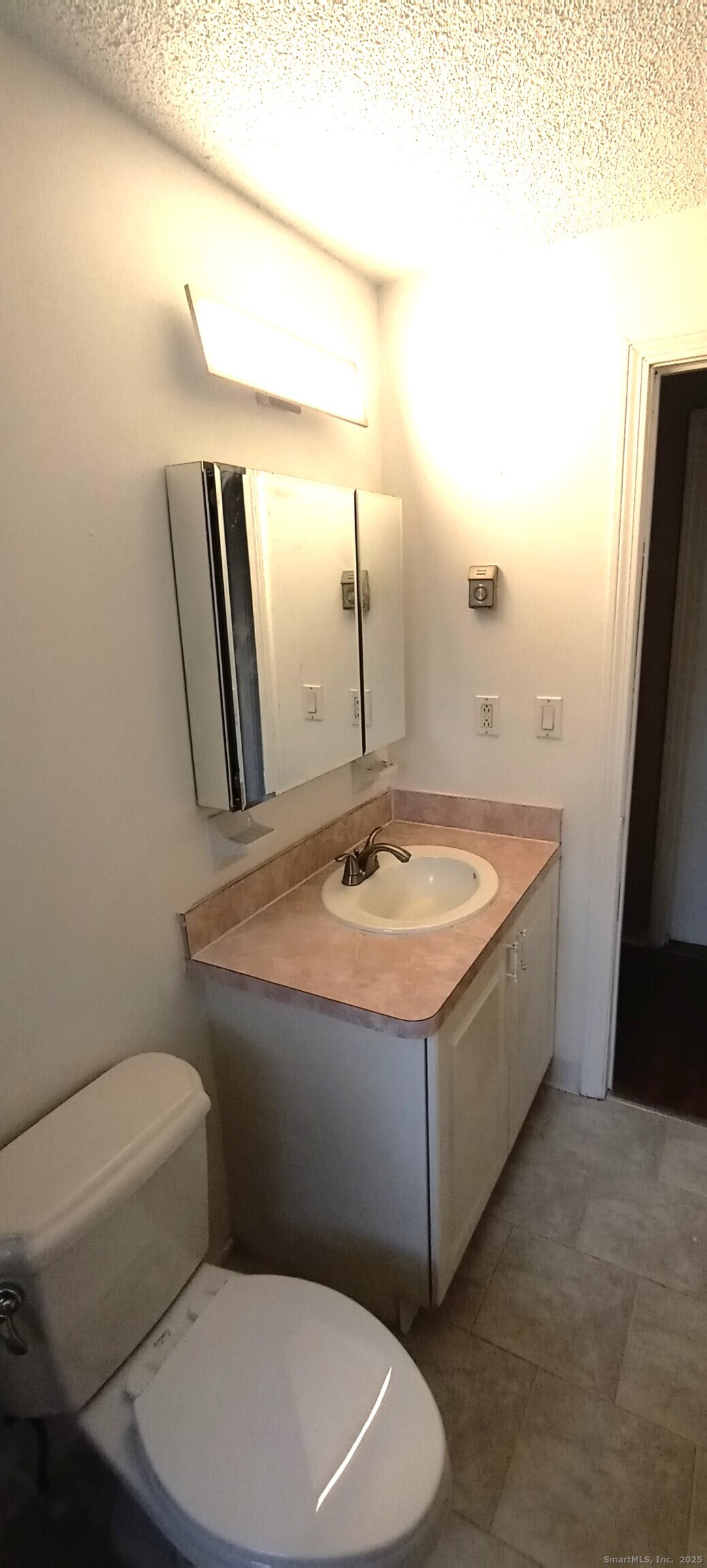 152 Surrey Drive, Unit 156 Bristol, CT 06010 - Photo 3 of 4 a bathroom with a sink a toilet and mirror