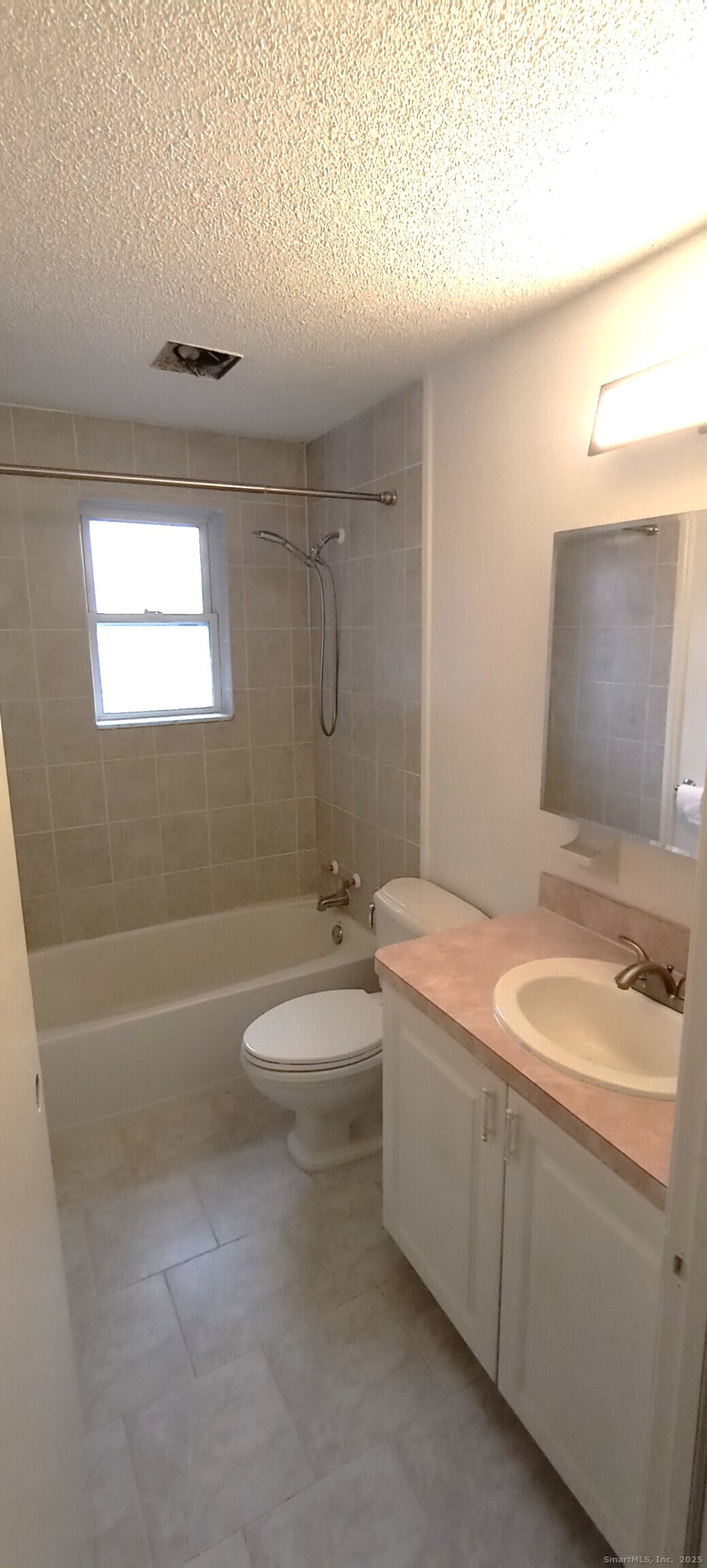 152 Surrey Drive, Unit 156 Bristol, CT 06010 - Photo 4 of 4 a bathroom with a granite countertop sink a toilet and bathtub