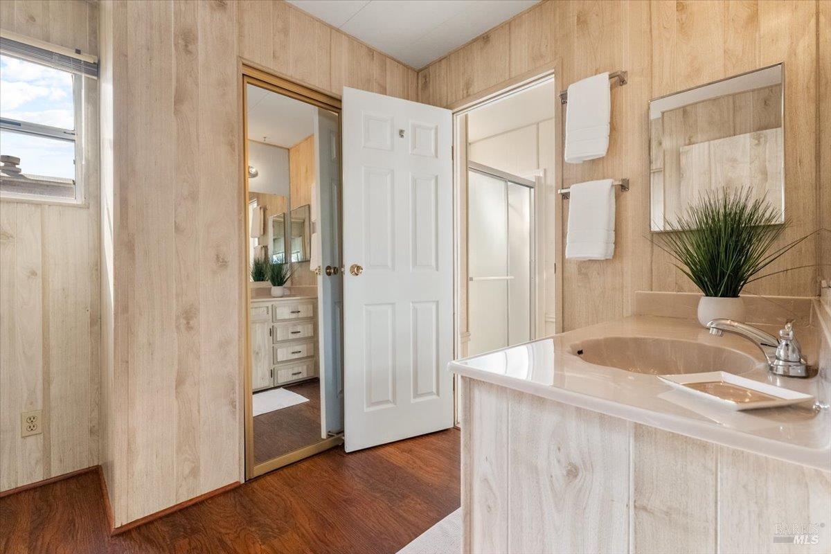 243 Parque Cabana Rohnert Park, CA 94928 - Photo 18 of 26 a bathroom with a sink a mirror and a shower