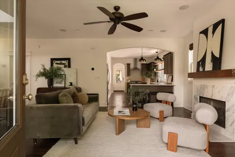 a living room with furniture and a chandelier