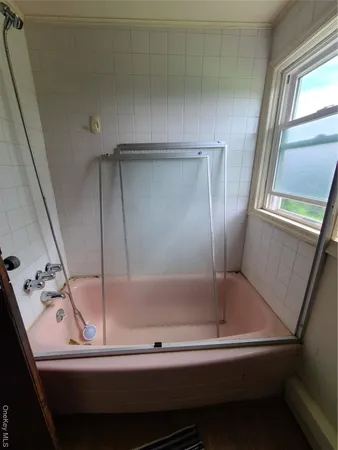 a bathroom with a bathtub and a shower