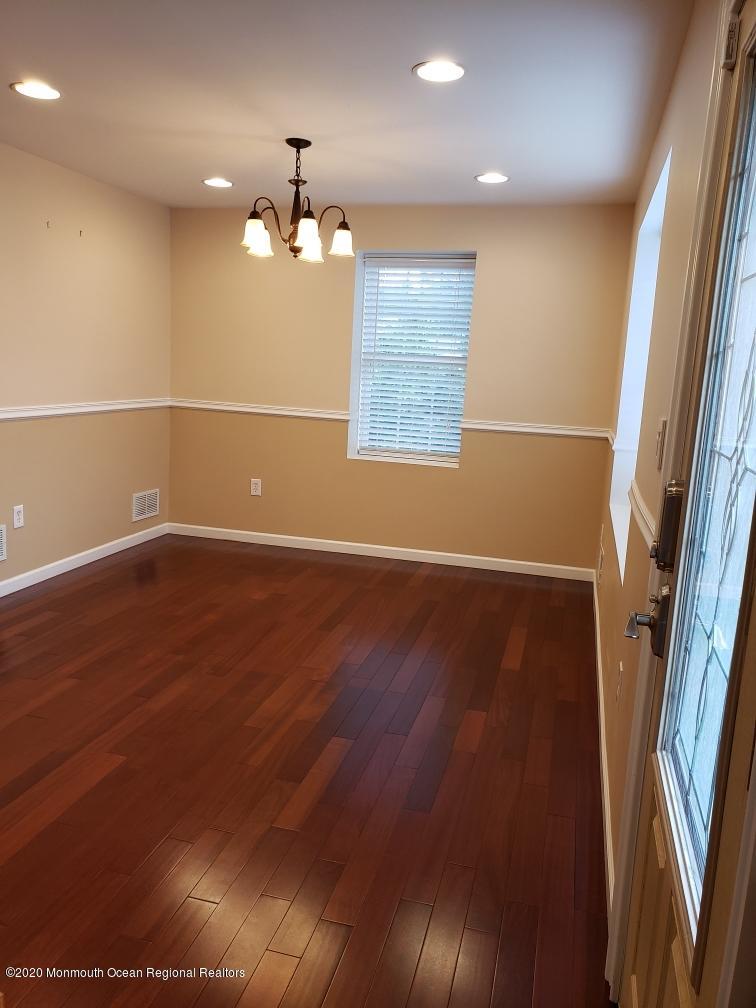 227 Georgia Road Freehold, NJ 07728 - Photo 11 of 79 an empty room with wooden floor and windows