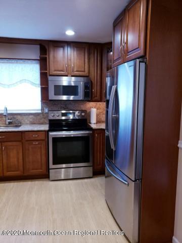 227 Georgia Road Freehold, NJ 07728 - Photo 20 of 79 a kitchen with granite countertop stainless steel appliances and wooden cabinets