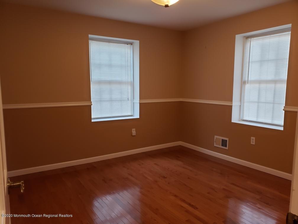 227 Georgia Road Freehold, NJ 07728 - Photo 28 of 79 a view of an empty room with wooden floor and a window