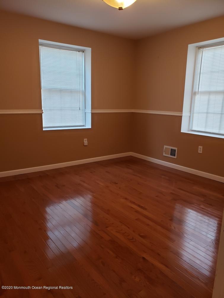 227 Georgia Road Freehold, NJ 07728 - Photo 29 of 79 an empty room with wooden floor and windows