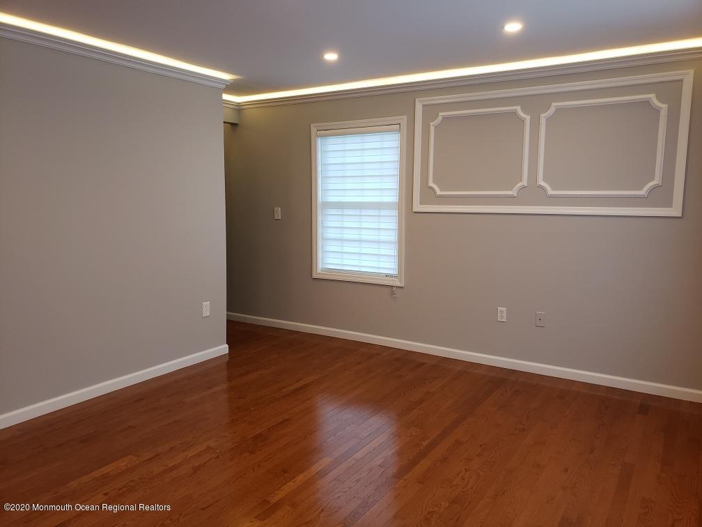 227 Georgia Road Freehold, NJ 07728 - Photo 41 of 79 a view of an empty room with wooden floor and a window
