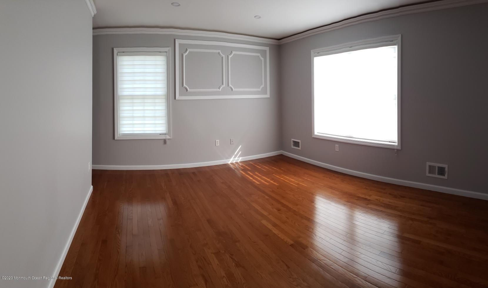 227 Georgia Road Freehold, NJ 07728 - Photo 42 of 79 an empty room with wooden floor and windows