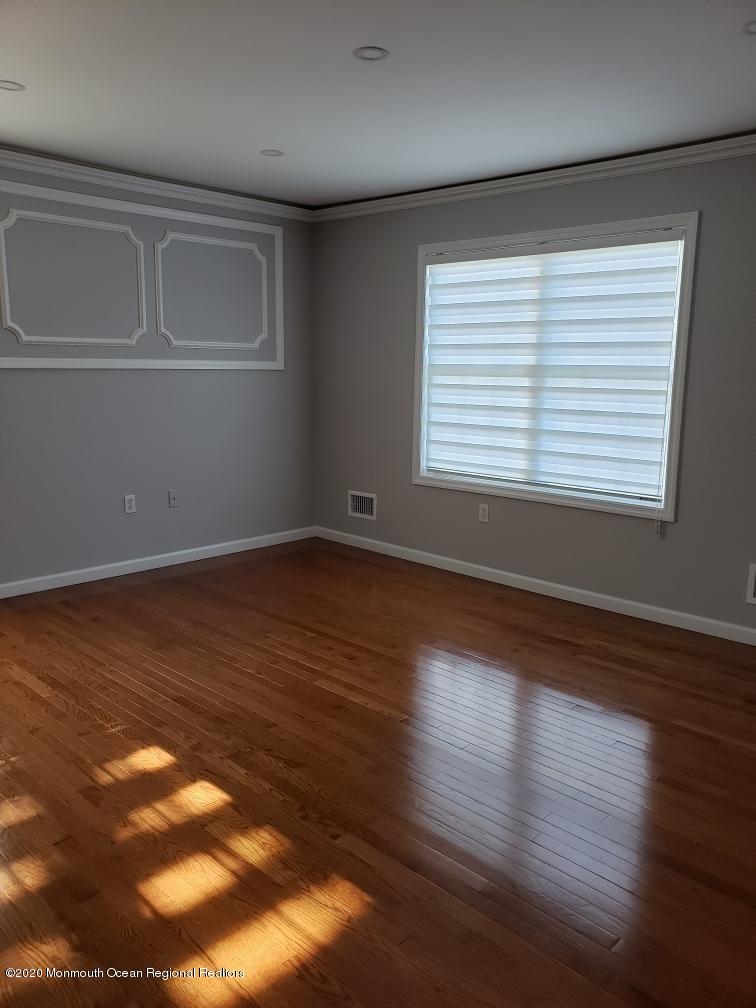 227 Georgia Road Freehold, NJ 07728 - Photo 44 of 79 a view of an empty room with wooden floor and a window