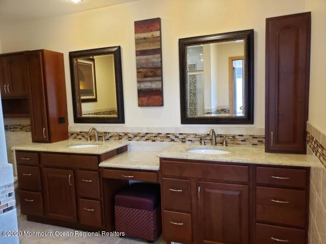 227 Georgia Road Freehold, NJ 07728 - Photo 58 of 79 a bathroom with a double vanity sink and mirror