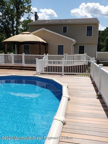 227 Georgia Road Freehold, NJ 07728 - Photo 61 of 79 a view of a house with a deck and a yard