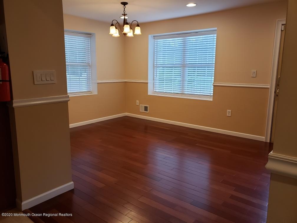 227 Georgia Road Freehold, NJ 07728 - Photo 10 of 79 a view of empty room with wooden floor and fan