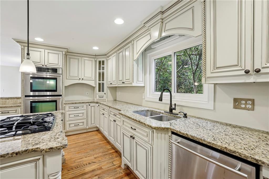 1843 Vancroft Court Atlanta, GA 30338 - Photo 11 of 46 a kitchen with stainless steel appliances granite countertop a sink stove and cabinets