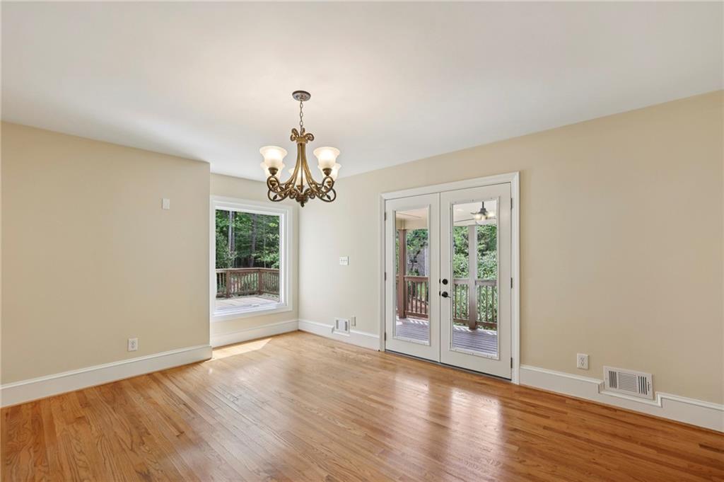 1843 Vancroft Court Atlanta, GA 30338 - Photo 15 of 46 a view of a livingroom with a chandelier wooden floor and windows