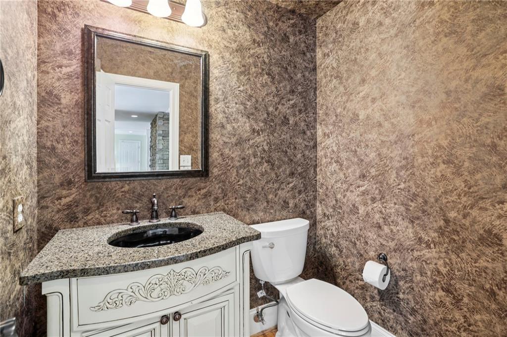 1843 Vancroft Court Atlanta, GA 30338 - Photo 16 of 46 a bathroom with a toilet sink and mirror