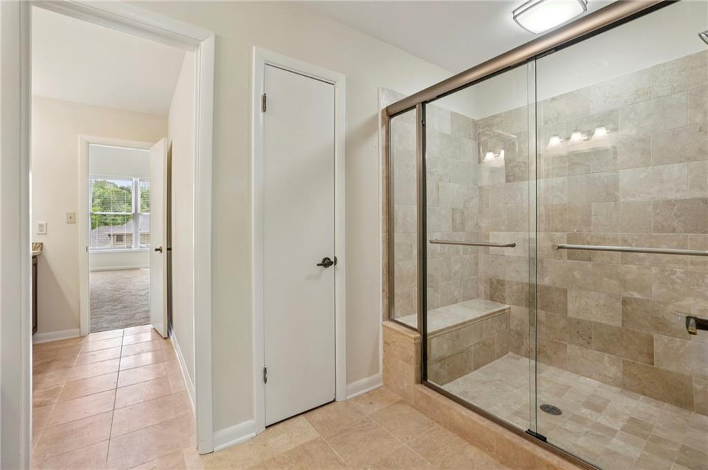 1843 Vancroft Court Atlanta, GA 30338 - Photo 21 of 46 a bathroom with a glass shower door