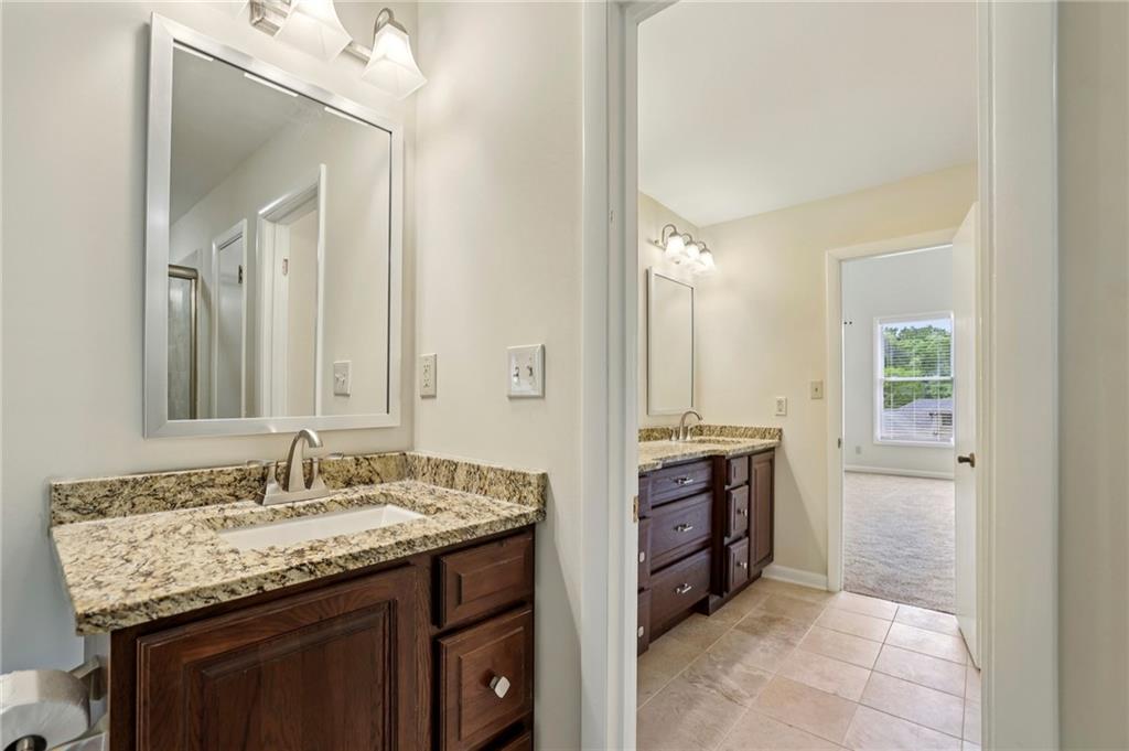 1843 Vancroft Court Atlanta, GA 30338 - Photo 23 of 46 a bathroom with a granite countertop sink and a mirror