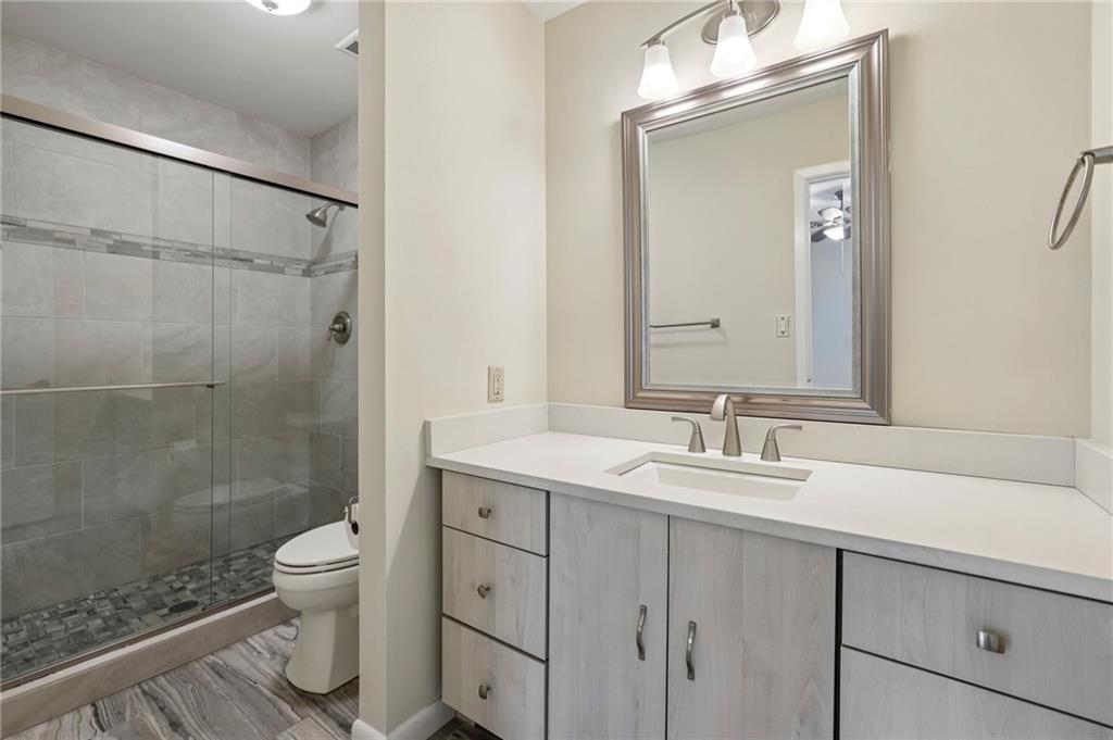 1843 Vancroft Court Atlanta, GA 30338 - Photo 26 of 46 a bathroom with a sink a toilet and a mirror