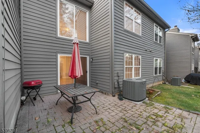 a view of house with backyard and sitting area