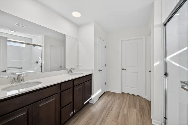a bathroom with a double vanity sink and mirror