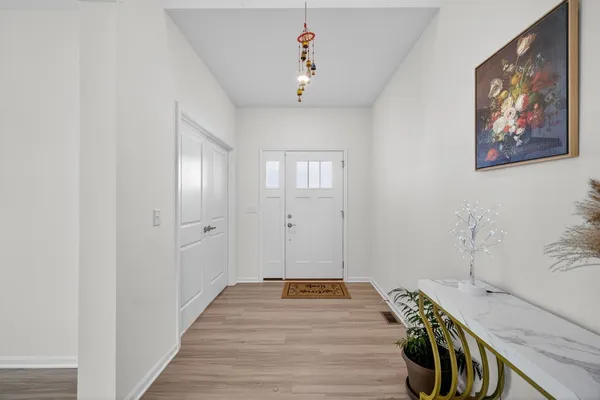 a view of a bedroom with wooden floor