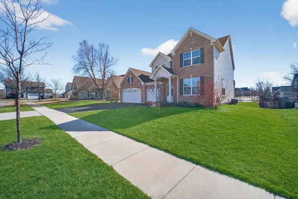 a front view of house with yard and green space
