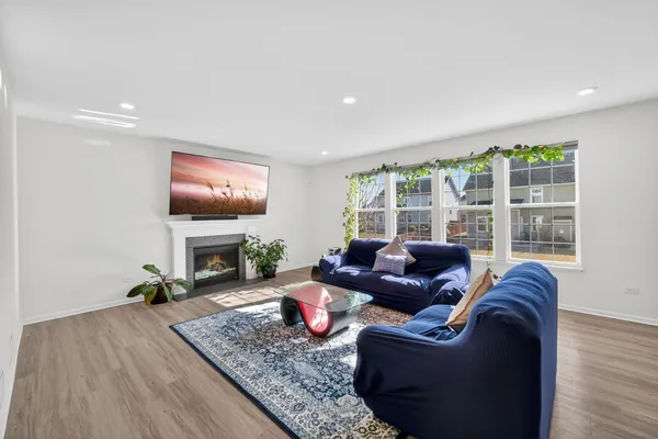 a living room with furniture a fireplace and a flat screen tv