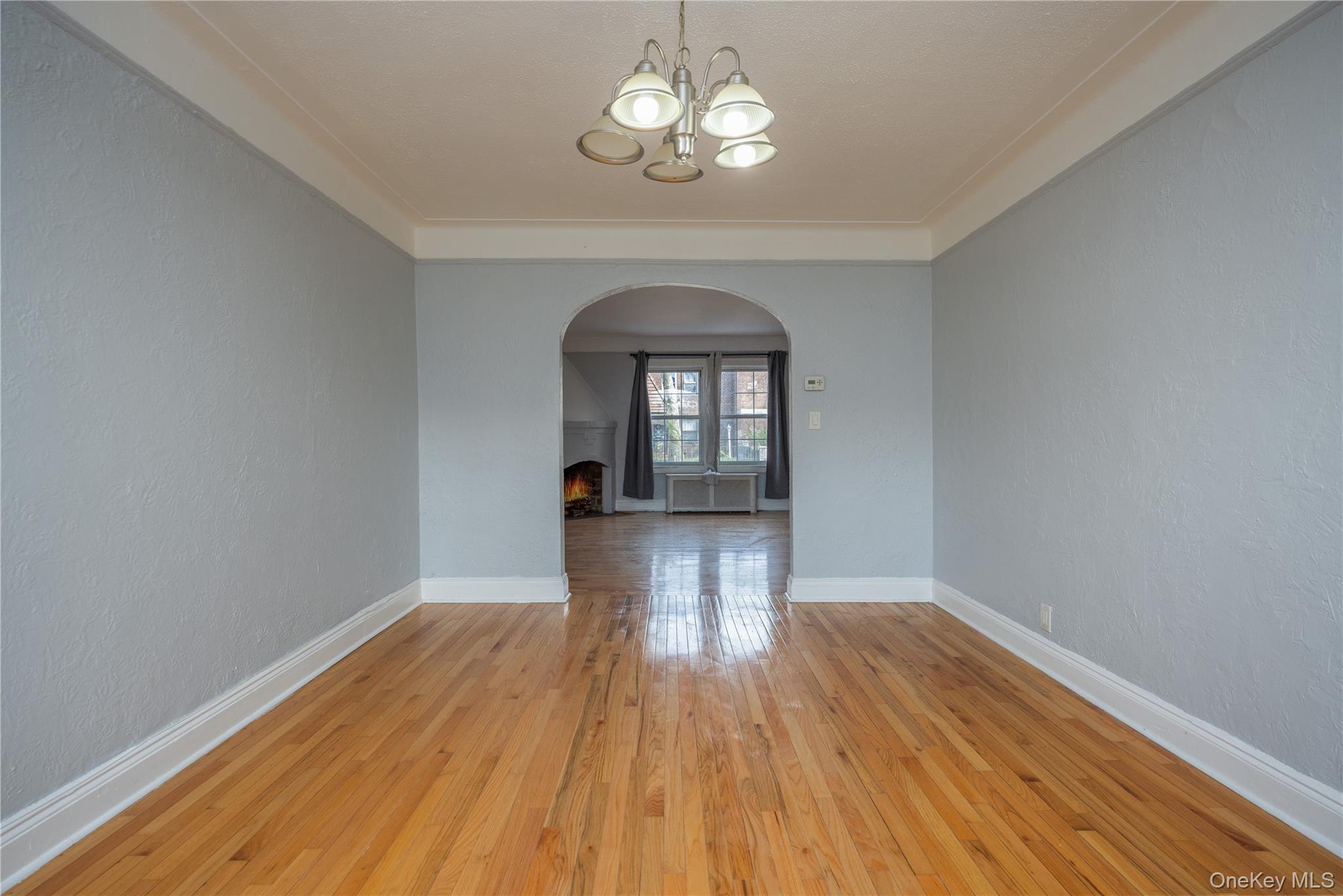 179-65 Selover Road Queens, NY 11434 - Photo 9 of 33 Dining Room10'6" x 14'9"Hardwood flooring extends throughout, complemented by a decorative arched doorway, light gray walls and white trim