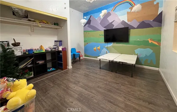 a living room with furniture a flat screen tv and a table