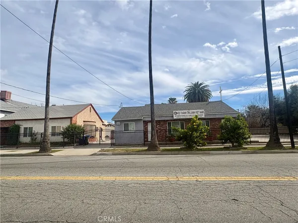 a view of a tall building next to a road