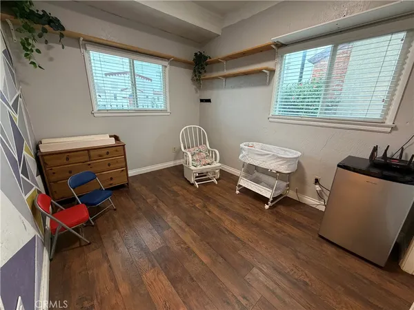 a bedroom with a bed and a dresser in it