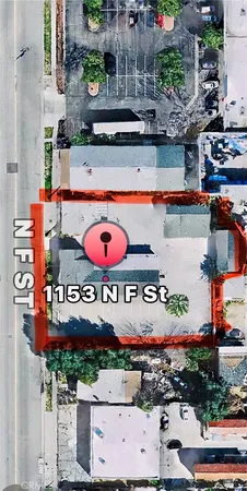 an aerial view of a swimming pool with outdoor seating