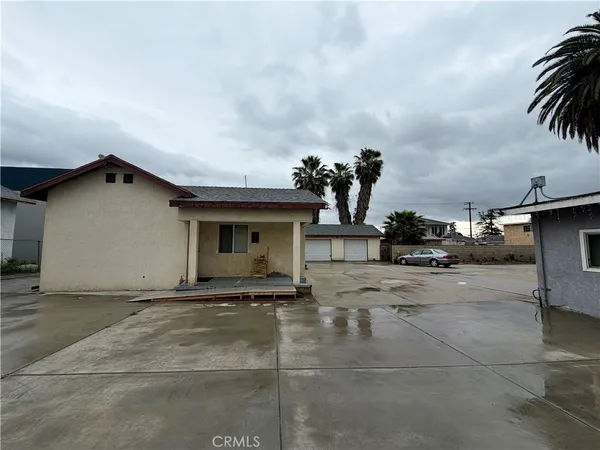 front view of a house with a yard and garage
