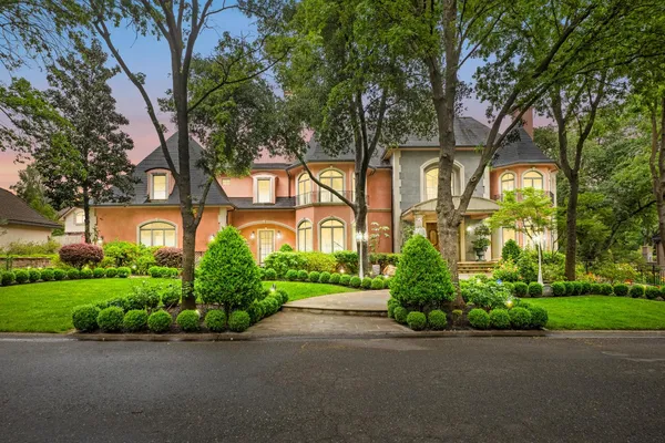 an aerial view of a house with outdoor space and a lake view in back