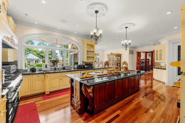 a large white kitchen with a large window
