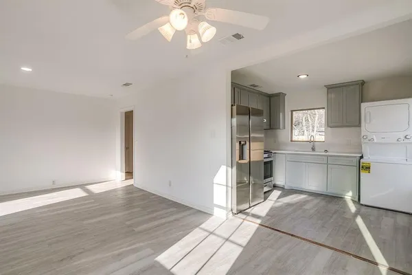 a view of a kitchen with a sink cabinets and wooden floor