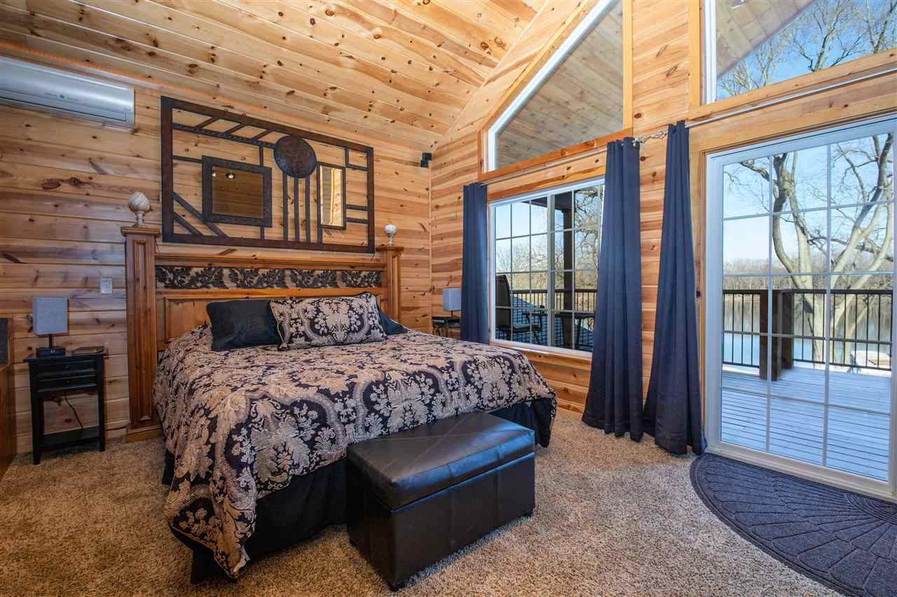 7372 North River Road Byron, IL 61010 - Photo 18 of 40 a bedroom with a bed and wooden floor
