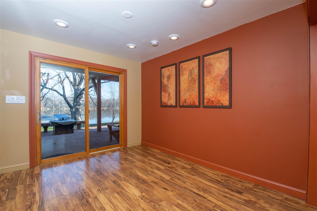 7372 North River Road Byron, IL 61010 - Photo 5 of 40 an empty room with wooden floor and windows