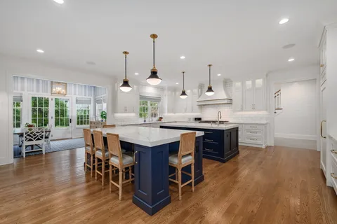 a living room with furniture a fireplace and a large window