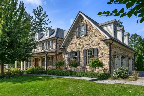a front view of a house with a garden and garage