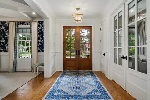 a kitchen with stainless steel appliances granite countertop a sink a stove and a wooden floors