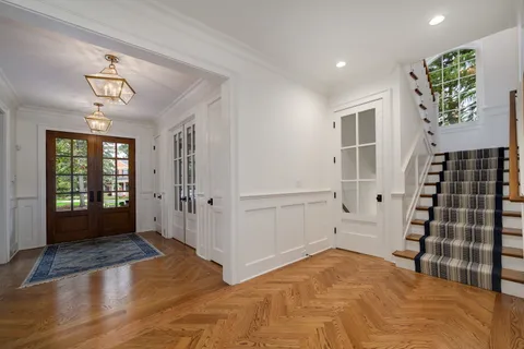 a kitchen with stainless steel appliances a dining table chairs stove and kitchen view