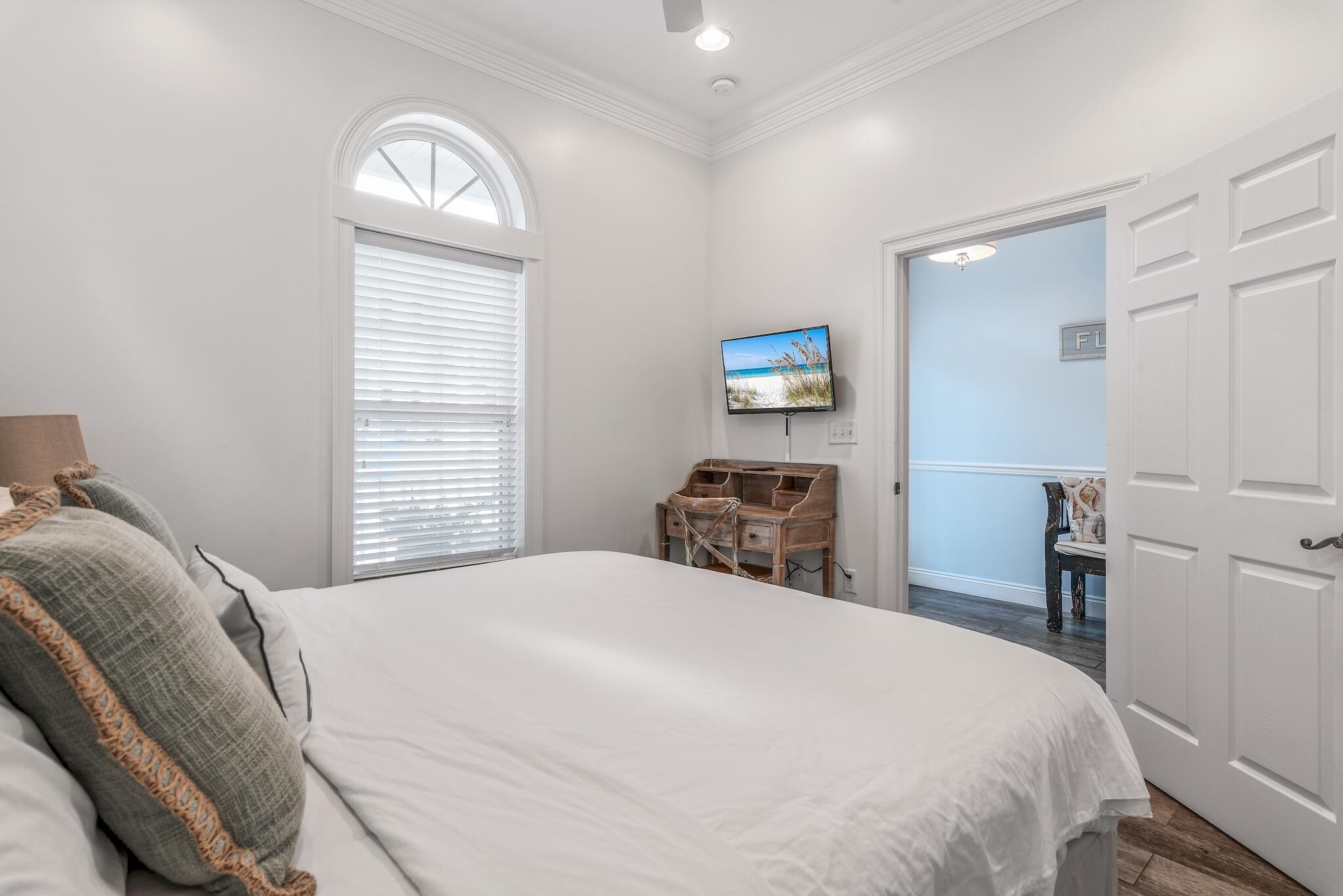 55 The Greenway Loop Panama City Beach, FL 32461 - Photo 12 of 32 a bedroom with a bed and a window