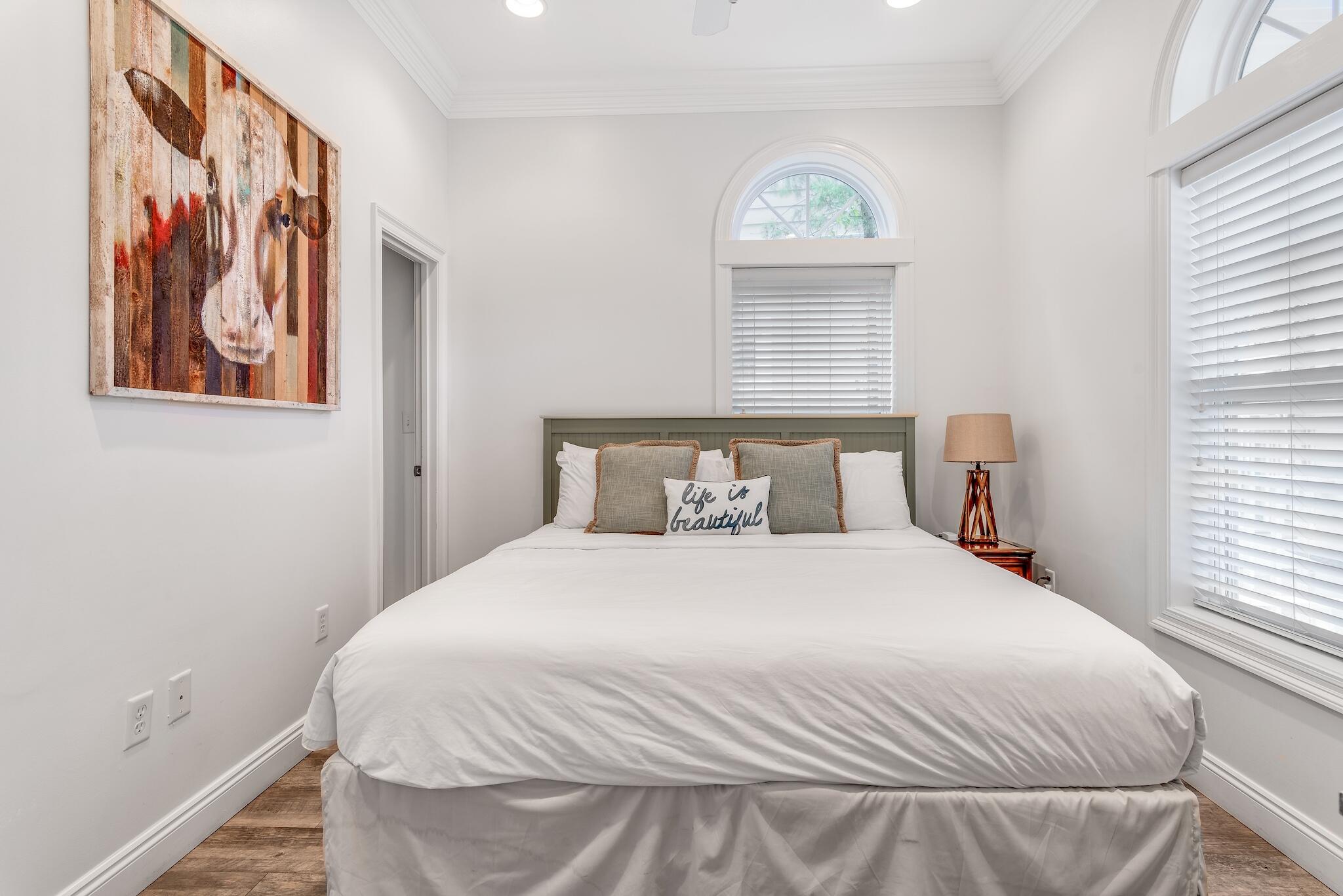 55 The Greenway Loop Panama City Beach, FL 32461 - Photo 13 of 32 a bedroom with a bed and a window