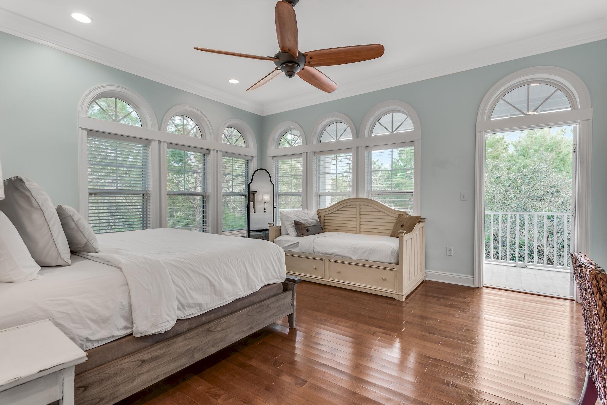 55 The Greenway Loop Panama City Beach, FL 32461 - Photo 15 of 32 a bedroom with a large bed and a large window