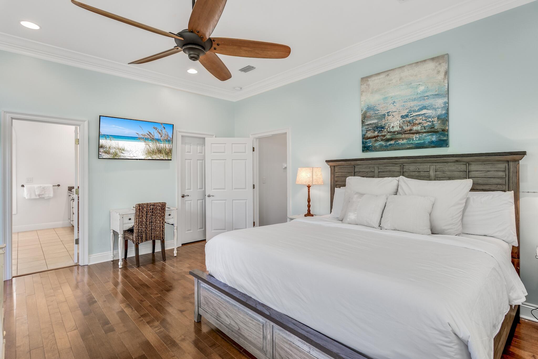 55 The Greenway Loop Panama City Beach, FL 32461 - Photo 17 of 32 a bedroom with a bed and a painting on the wall