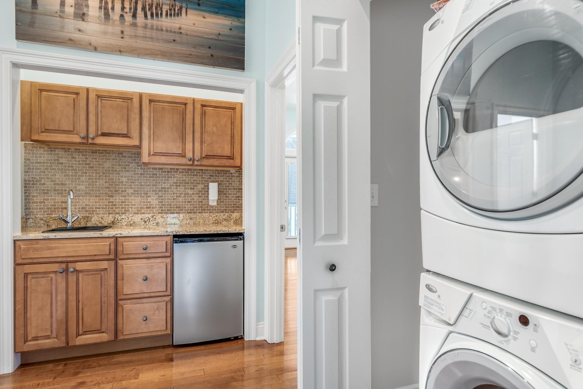 55 The Greenway Loop Panama City Beach, FL 32461 - Photo 21 of 32 a view of a kitchen with washer and dryer
