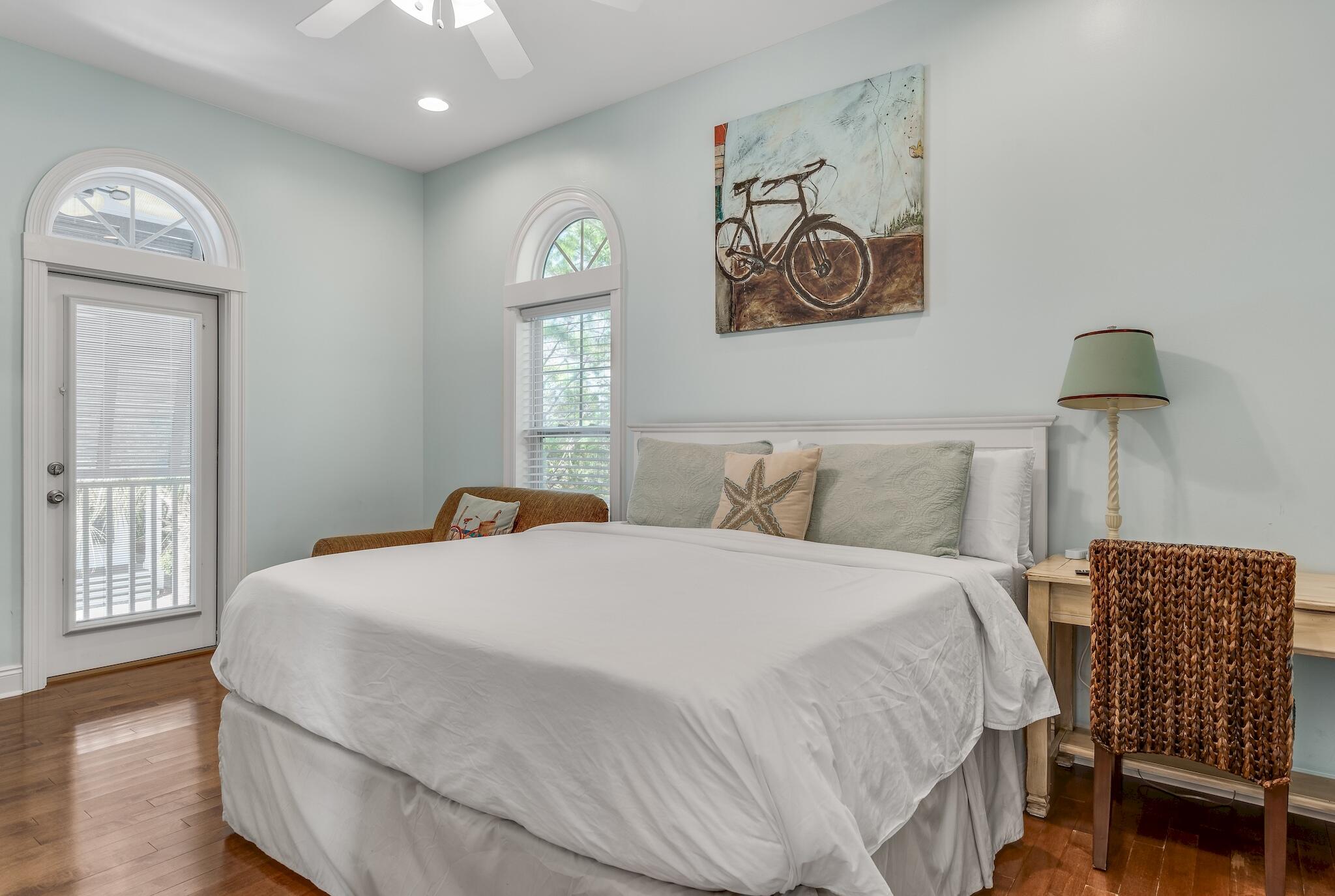 55 The Greenway Loop Panama City Beach, FL 32461 - Photo 22 of 32 a bedroom with a bed and a painting on the wall